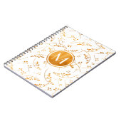 Stilvolle Goldbeeren aus Monogramm auf weißem Notizblock (Linke Seite)