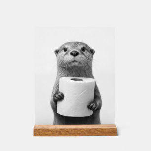 Stoischer Otter hält Toilettenpapierrolle Schwarz Acrylschild