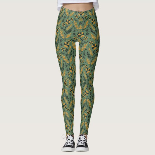 Stylized botanical orange and black floral pattern leggings (Vorderseite)