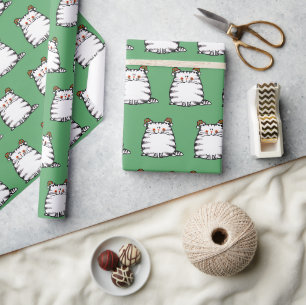 Süße dicke Katze mit zwei Weihnachtsmützen Geschenkpapier