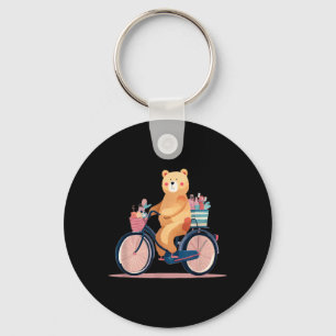 Süße Frau fährt Fahrrad mit lustiger Teddybär-Graf Schlüsselanhänger