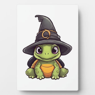 Süße Halloween-Schildkröte mit einem Hexenhut. Fotoplatte