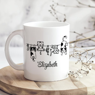 Süße hängende Kätzchen mit individuellem Namen Kaffeetasse