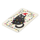 Süße Katze mit Weihnachtsmannmütze und Lichtern zu Magnet (Linke Seite)