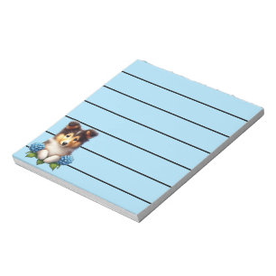Süßer Collie-Welpe mit blauen Blumen  Notizblock