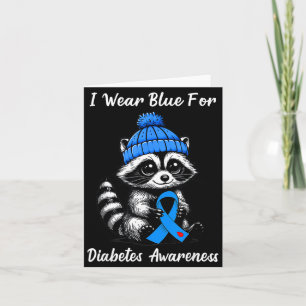 Süßer Herbstwaschbär trägt blaues Band für Diabete Karte