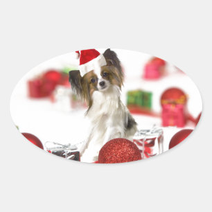 Süßer Papillon-Hund Weihnachten Santa Hut Ovaler Aufkleber