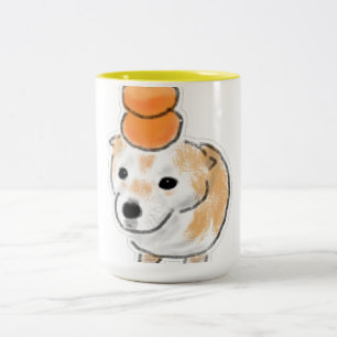Süßer Shiba-Hund mit Tangerinen Mandarinen auf dem Zweifarbige Tasse