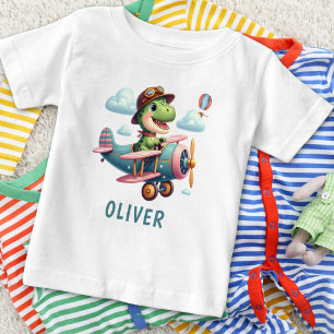 Süßer Trex-Dinosaur fliegt ein charmantes Flugzeug Baby T-shirt