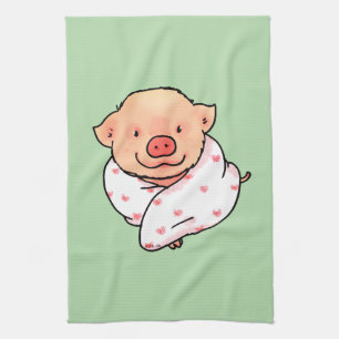 Süßes Babyferkel eingewickelt in eine Decke Geschirrtuch