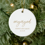Sydney Gold First Christmas Verlobt Modern Keramik Ornament<br><div class="desc">Moderne Weihnachtsschmuck mit zeitgenössischem typografischem Design mit "verlobt" in eleganter Schriftzypografie, mit Ihren Namen und Verlobungen Datum in einem einfachen und minimalen Layout. Auf der Rückseite ist dein LieblingsFoto. Das Farbdesign ist Gold und Weiß und kann im Designbearbeitungstool geändert werden. Dieses minimalistische Dekor ist ideal für ein Paar für ihr...</div>