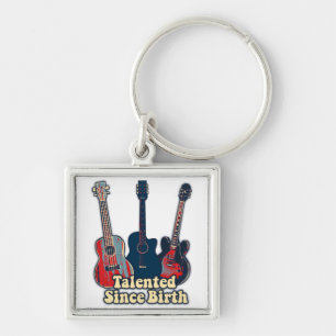Talentiert seit der Geburt. Retro farbige Gitarren Schlüsselanhänger