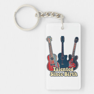 Talentiert seit der Geburt. Retro farbige Gitarren Schlüsselanhänger
