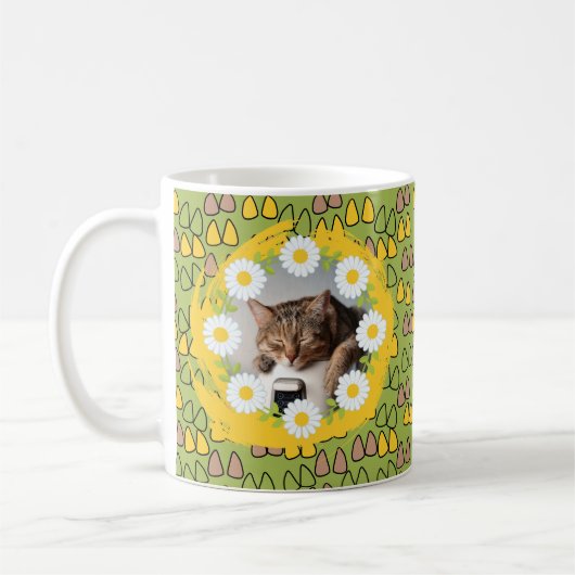 Täsche und Katzenohren auf einem grünen Kaffeekats Kaffeetasse (Links)