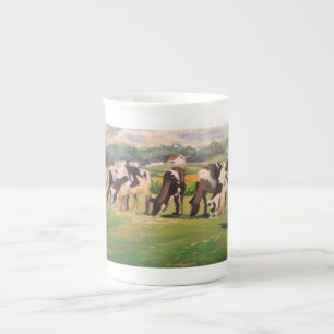 Tasse mit dem Weiden lassen der Kühe