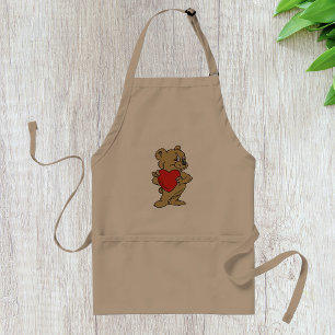 Teddy Bear hält eine Schürze des Roten Herzens