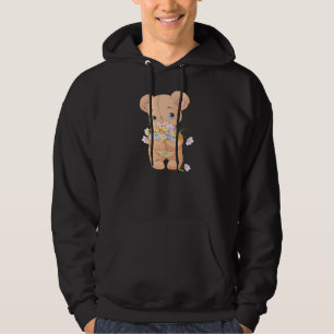 Teddybär, der einen Hoodie der Blumenstrauß-Män
