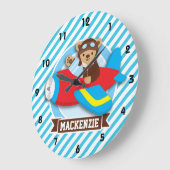 Teddybär-Pilot im roten Spielzeug-Flugzeug; Blaue Große Wanduhr (Winkel)