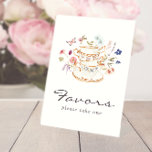 Tee-Gastgeschenke Pedestal-Zeichen Sockelschild<br><div class="desc">Lass Deinen besonderen Tag Blossom mit Tea Gastgeschenks Pedestal Sign! Atemberaubende, handbemalte Aquarellblumen in lila, staubblauen Farbtönen und Rosa mit Salbeigrün. Ob Sie nun ein Gartenhotel oder eine gemütliche, intime Ansammlung beherbergen, dieses hübsche Podest-Design wird Ihrer Veranstaltung eine besondere Touch des Charmes verleihen. Finden Sie koordinierende Produkte im Watercolor Wildblume...</div>
