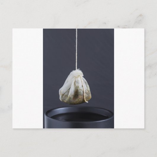 Teebeutel hängt in einer Tasse Postkarte (Vorderseite)