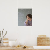 Teenaged boy in front of blackboard with math poster (Küche)
