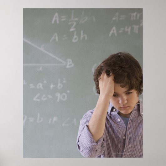 Teenaged boy in front of blackboard with math poster (Vorne)