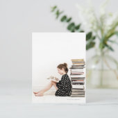 Teenagermädchen liest Comic Strip nach Stapel von Postkarte (Stehend Vorderseite)