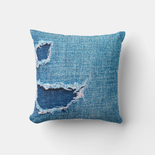 Textured denim background. Torn hole in the fabric Kissen
