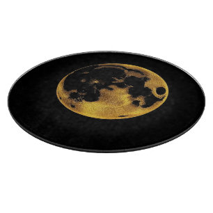 Texturierter goldener Mond auf dunklem Schwarz Schneidebrett