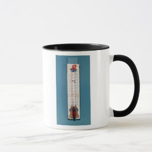 Thermometer übergestiegen mit einer phrygian Mütze Tasse