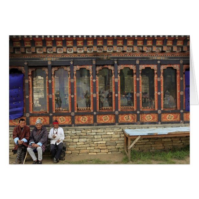 Three men sit on a bench at the Memorial Chorten (Vorderseite (Horizontal))