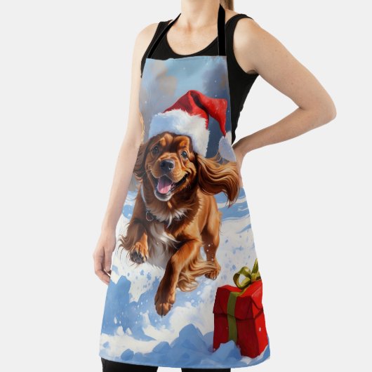 Tibetischer Spanier, der mit Weihnachtshut in Schn Schürze (InSitu)