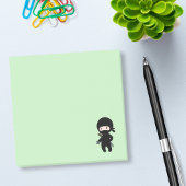 Tiny Ninja Holding Throwing Star auf Green Post-it Klebezettel