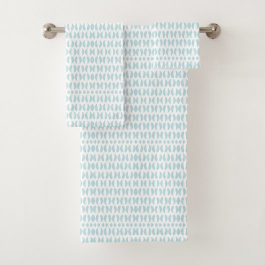 Towels with a light blue fish pattern hang neatly badhandtuch set