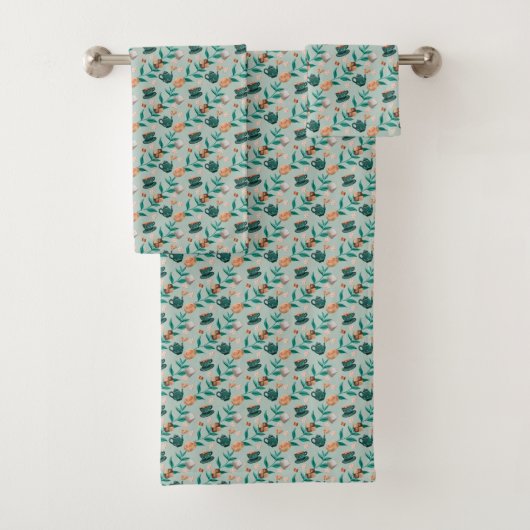 Towels with a teal floral pattern hang  badhandtuch set (Insitu)
