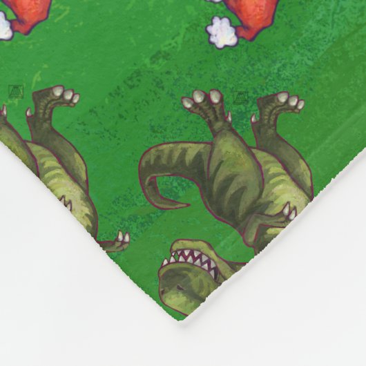TRex in Weihnachtsmannmütze auf Grün Fleecedecke (Ecke)