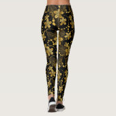 Tropische Blätter und Blume in Schwarz und Gold Leggings (Rückseite)