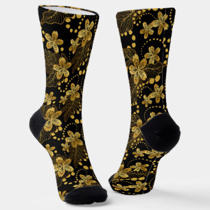 Tropische Blätter und Blume in Schwarz und Gold Socken