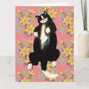 Tuxedo-Katze schlafend auf floralem Bett Karte