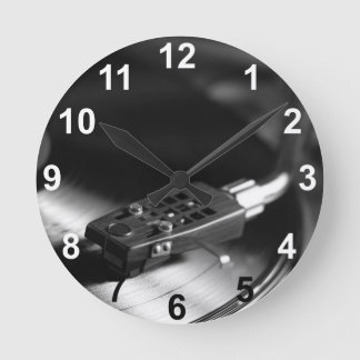 Uhr: Vinyl-Schallplatte auf einem Plattenspieler. Runde Wanduhr