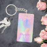 Unicorn rosa Glitzer Tropfen Name holografisch Schlüsselanhänger<br><div class="desc">Ein angesagter holografischer Hintergrund mit Einhorn- und Pastellfarben in Rosa,  lila,  Minzgrün. Dekoriert mit Imitaten Glitzer Tropfen,  Farbe Tropfausdruck aussehen. Personalisieren Sie Ihren Namen und fügen Sie ihn hinzu. Lila Buchstaben. Ein bisschen Alltagsglanz,  um den Tag angenehm zu gestalten!</div>