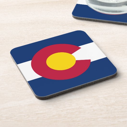 Untersetzer aus hartem Kunststoff mit der Fahne Co (Linke Seite)