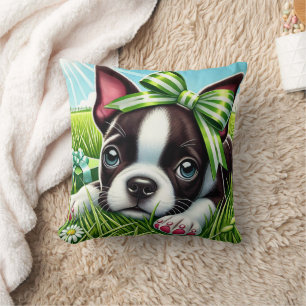 Verspielter Boston Terrier Welpe mit grünem Schlei Kissen