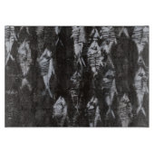 Versteinerte weiße Fische auf schwarzem Schneidebrett (Vorderseite)