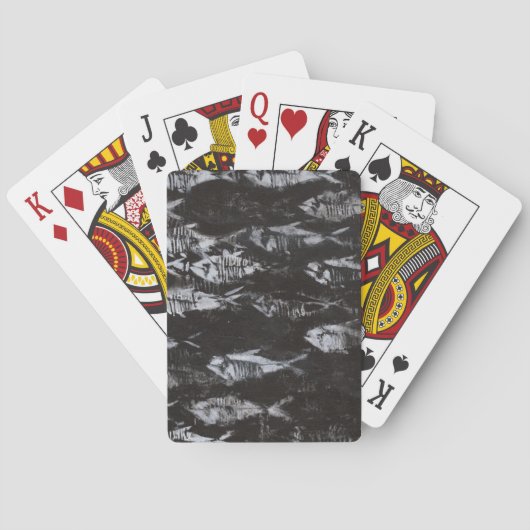 Versteinerte weiße Fische auf schwarzem Spielkarten (Rückseite)