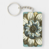 Verzierte Blumenmedaille über hellblauen Hintergru Schlüsselanhänger (Vorderseite)