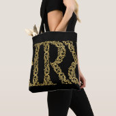 Verziertes Gold R Monogram Erstdesign auf einer be Tasche (Von Nahem)