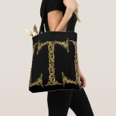 Verziertes Gold T Monogram Erstdesign auf einer be Tasche (Von Nahem)