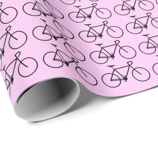Viele schwarze Fahrradsymbole auf einem rosa Hinte Geschenkpapier (Rolleneckpunkt)