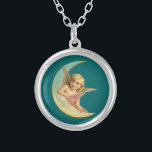 Vintage Image - Engel sitzend auf einem Crescent M Versilberte Kette<br><div class="desc">Ein süß Vintager zeichn. Ein friedlicher und freundlich aussehender kinderähnlicher Engel,  der sich auf der Kurve eines Halbmondes auf dunkelgrünem Hintergrund ruht.</div>